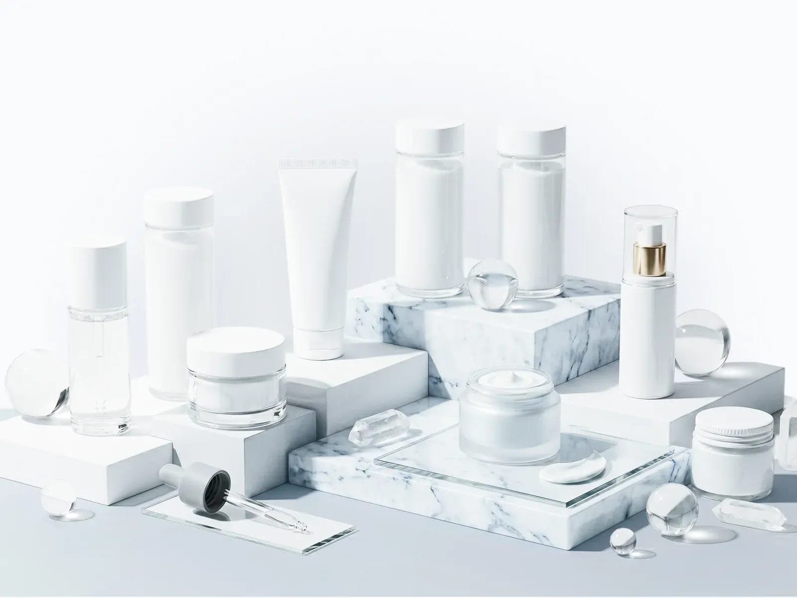 Unbranded personal care packaging arranged on a marble surface.